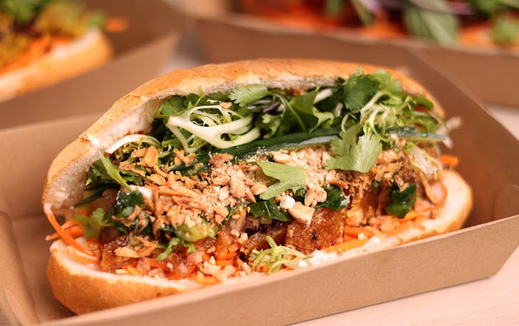 A banh mi with shallots on top. 