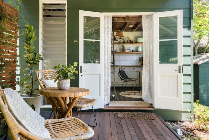 a deck in front of a tiny house