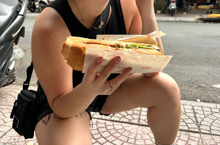 Person holding banh mi